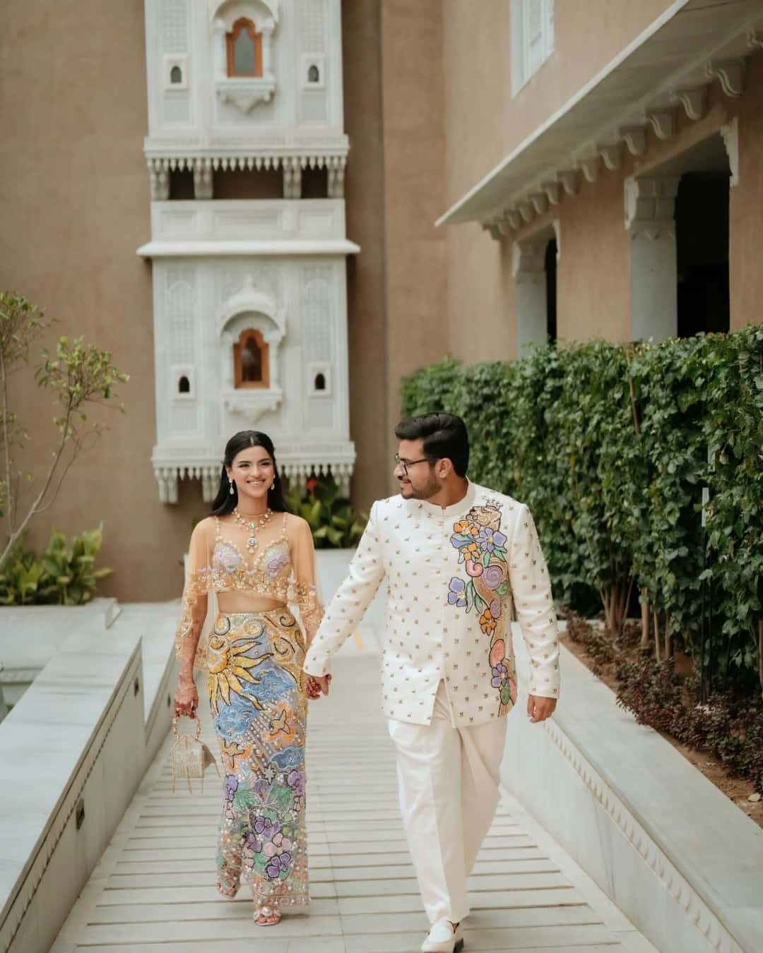 Couple walking hand in hand at a heritage wedding venue
