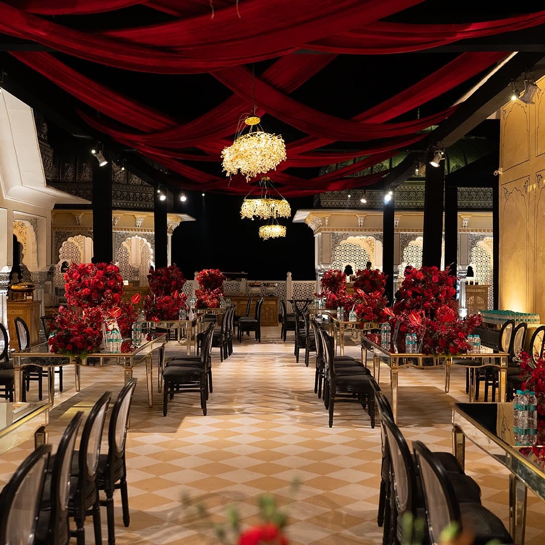 A banquet hall fully dressed with florals and seating, ready ahead of guests arriving