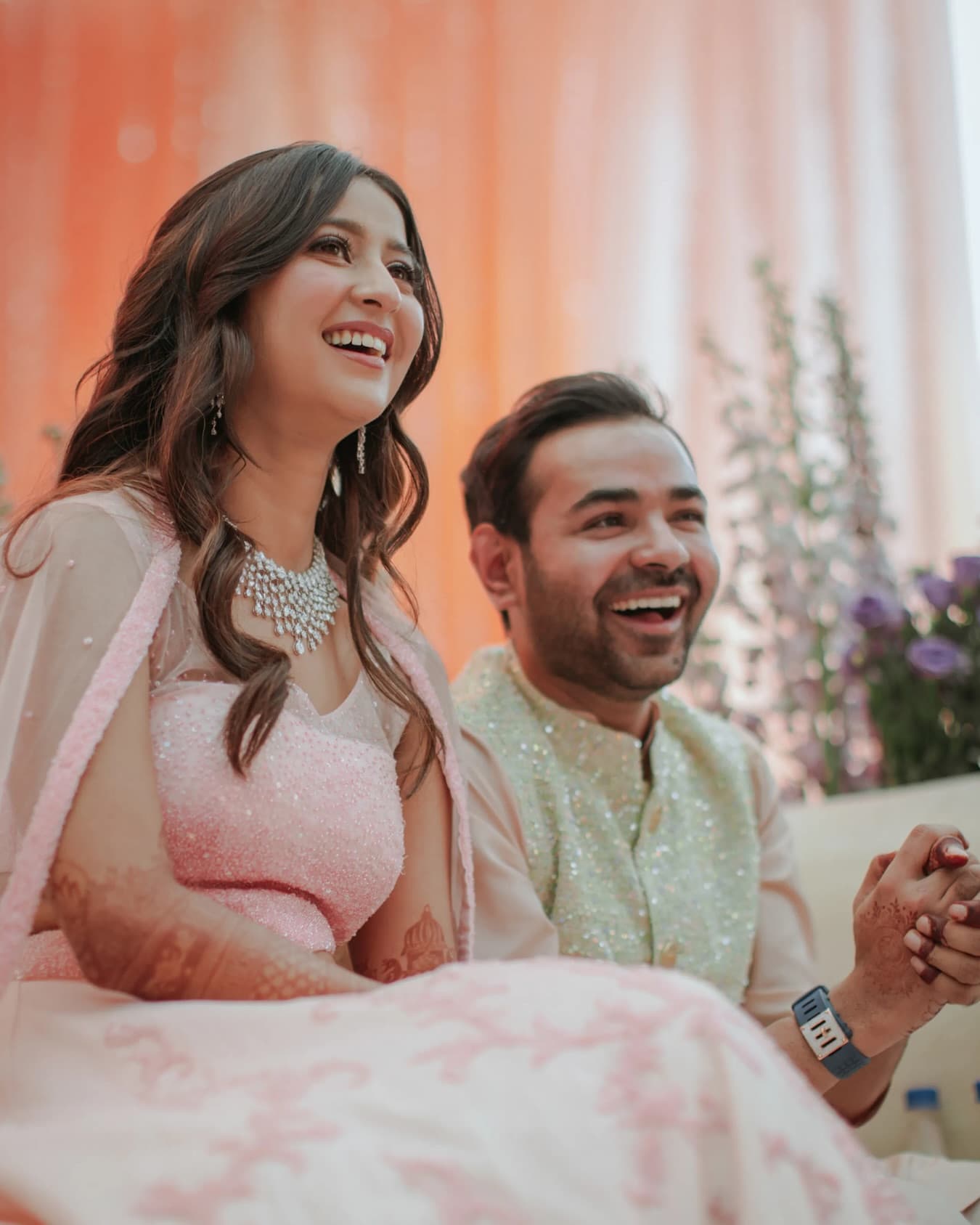 A couple sitting together laughing during a relaxed conversation